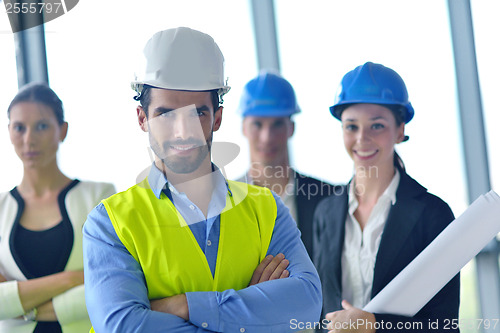 Image of business people and construction engineers on meeting