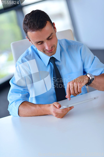 Image of business man using tablet compuer at office