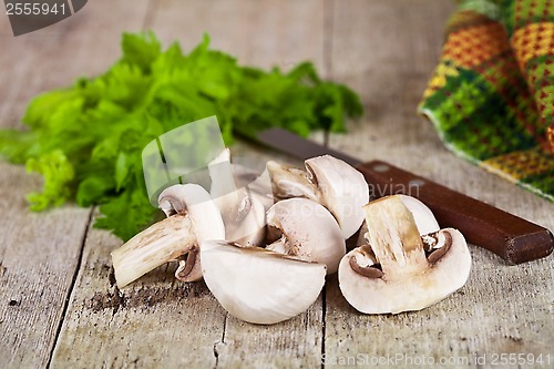 Image of  fresh champignons, parsley and old knife