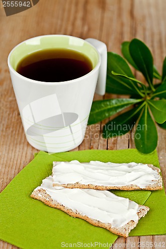 Image of cup of tea and crackers with cream cheese 
