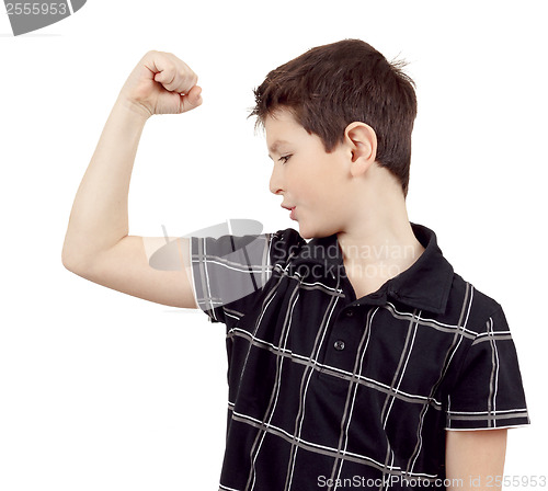 Image of Portrait of a young boy with hand raised up and showing muscles