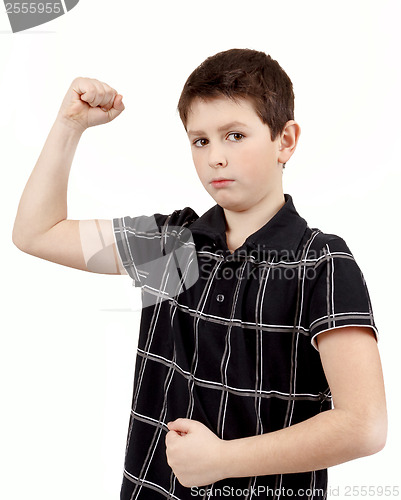 Image of Portrait of a young boy with hand raised up and showing muscles