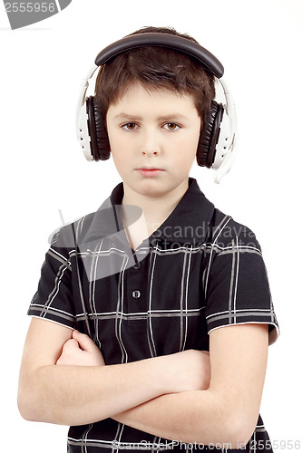 Image of Portrait of a young boy listening to music on head