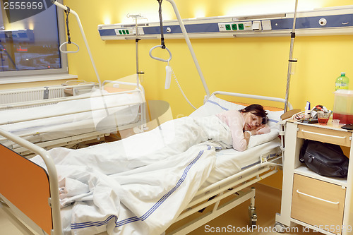 Image of sad middle-aged woman lying in hospital