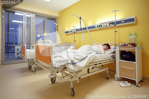 Image of sad middle-aged woman lying in hospital