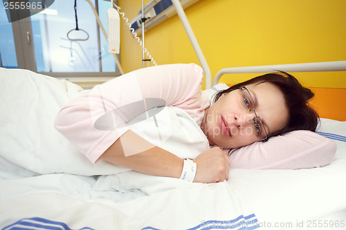 Image of sad middle-aged woman lying in hospital