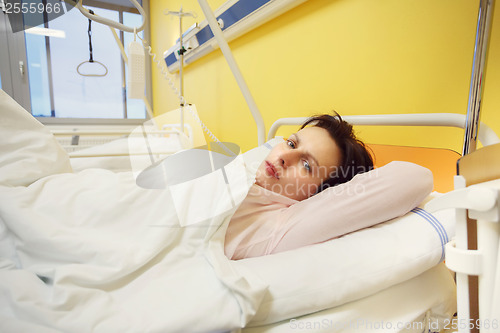 Image of sad middle-aged woman lying in hospital