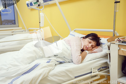 Image of sad middle-aged woman lying in hospital