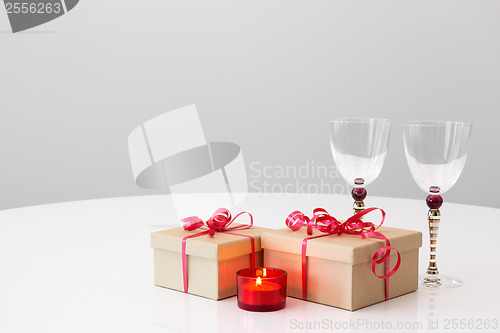 Image of Gifts, wineglasses and candlelight