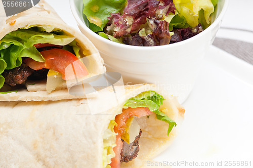 Image of kafta shawarma chicken pita wrap roll sandwich