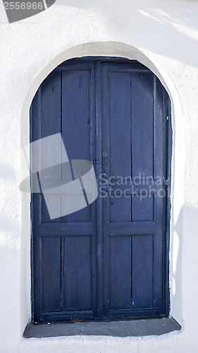 Image of Blue door and white house in Santorini