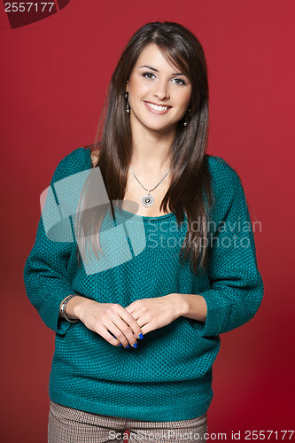 Image of Young smiling brunette woman in warm clothes