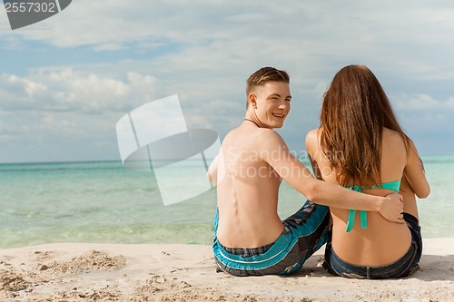 Image of Happy young couple sunbathing