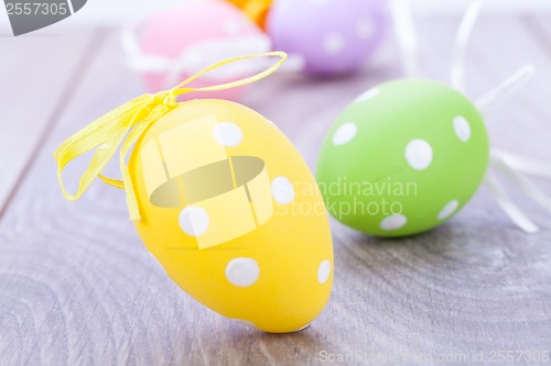 Image of colorful easter egg decoration on wooden background