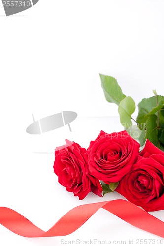 Image of Bouquet of red roses with ribbon border