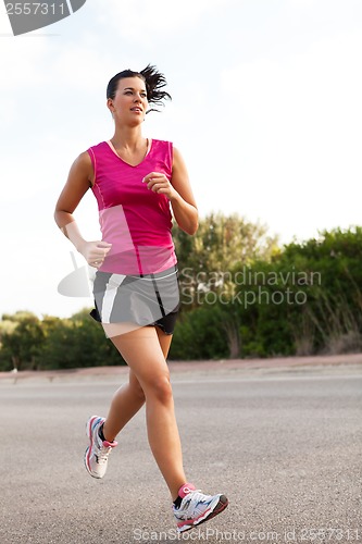 Image of Caucasian woman practicing jogging in the park