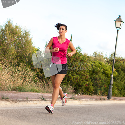 Image of Caucasian woman practicing jogging in the park