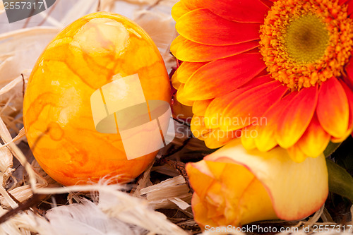 Image of Vivid orange Easter egg with a gerbera and rose