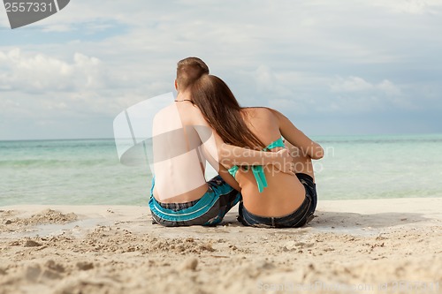 Image of Happy young couple sunbathing