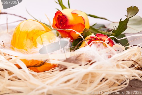 Image of Vivid orange Easter egg with a gerbera and rose