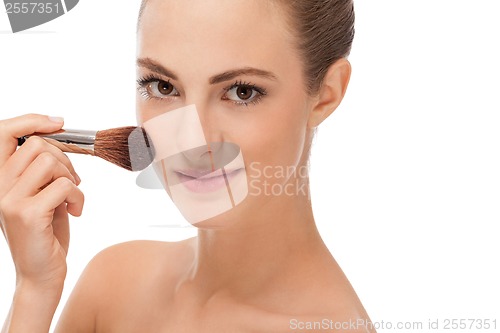 Image of apllying powder make up on face portrait