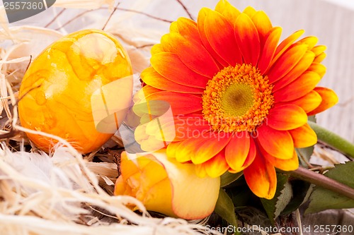 Image of Vivid orange Easter egg with a gerbera and rose