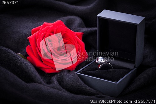 Image of red rose and diamond ring in a box 