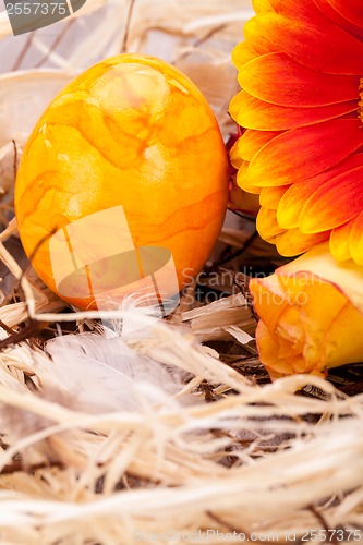 Image of Vivid orange Easter egg with a gerbera and rose