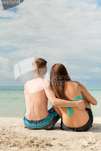 Image of Happy young couple sunbathing