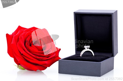 Image of Engagement ring with a bunch of red roses