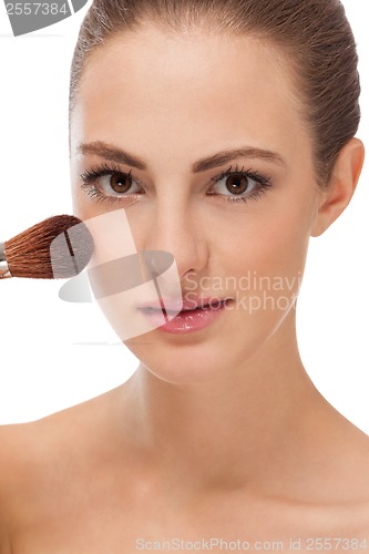 Image of apllying powder make up on face portrait