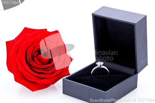 Image of Engagement ring with a bunch of red roses