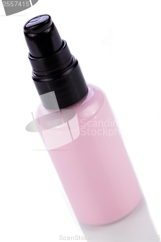 Image of pink plastic bottle of cosmetic cream isolated on white