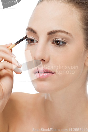 Image of doing the makeup brown eyeshadow on beautiful eyes