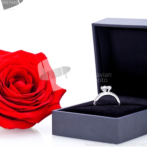 Image of Engagement ring with a bunch of red roses