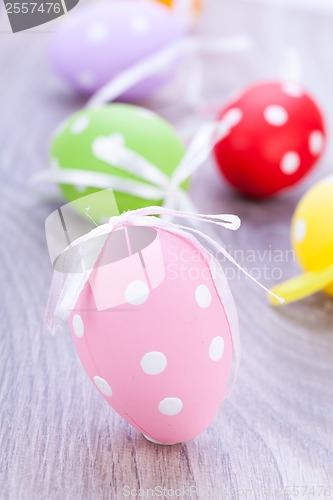 Image of colorful easter egg decoration on wooden background