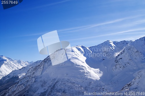 Image of Snowy sunlight mountains, view from off piste slope