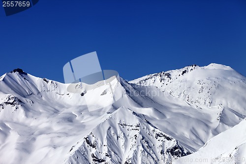 Image of Off piste snowy slope and blue clear sky