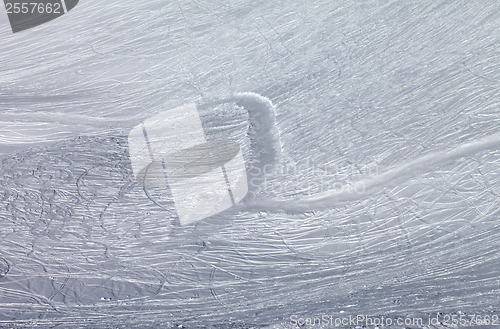 Image of Off-piste slope and snowy road with trace from ski and snowboard
