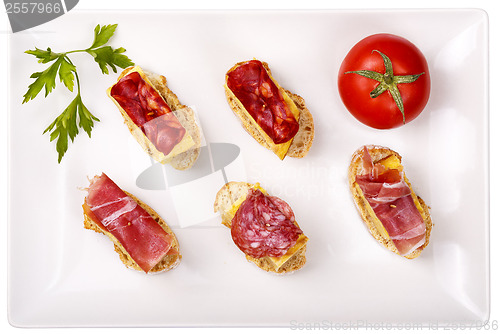 Image of thin slices of Iberian sausage omelette with bread