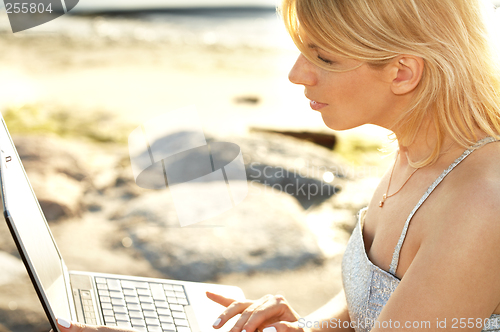 Image of outdoor picture of blond with laptop