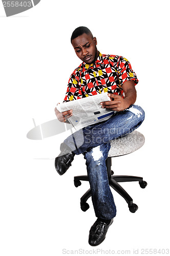 Image of Black man reading paper.