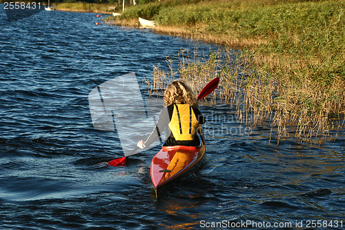 Image of Blond girl on a kayak on a lake in Denmark