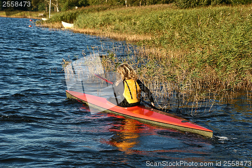 Image of Blond girl on a kayak on a lake in Denmark