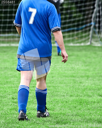 Image of Football player in blue without head