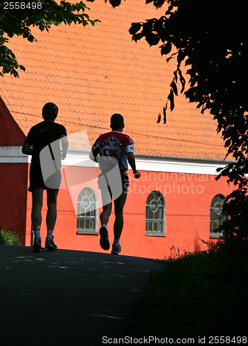 Image of People jogging in a city
