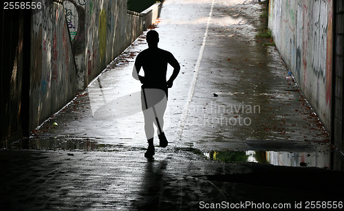 Image of People jogging in a city