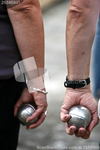 Image of Petanque players arms