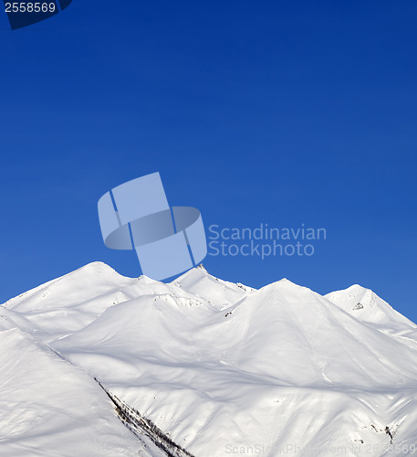 Image of Snowy mountains and blue sky