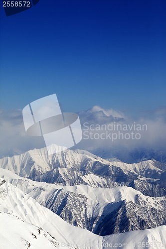 Image of Winter snowy mountains and blue sky with clouds